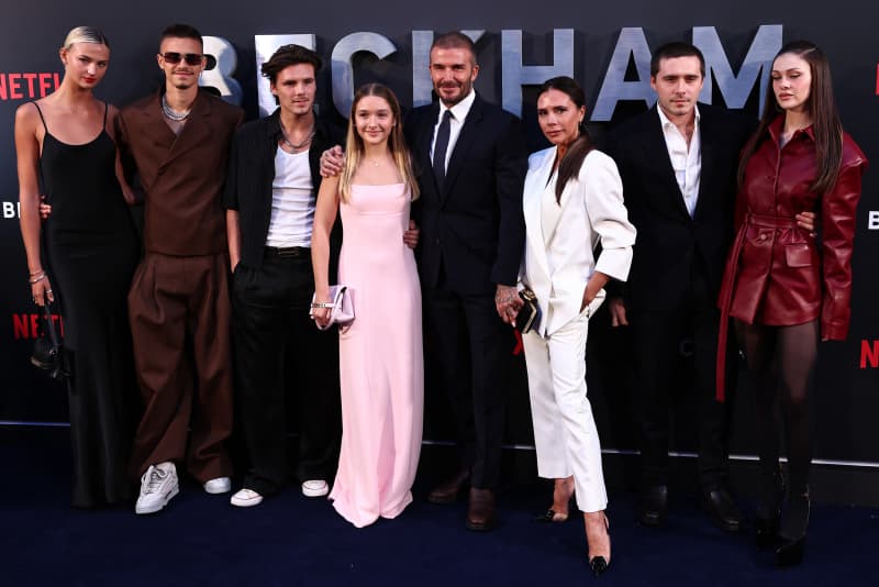 Former England footballer David Beckham (5L) and his wife Victoria Beckham (3R) pose on the red carpet with their children, and partners, (from L) Mia Regan, Romeo Beckham, Cruz Beckham, Harper Beckham, Brooklyn Beckham and Nicola Peltz Beckham upon arrival to attend the Premiere of "Beckham" in London on October 3, 2023. (Photo by HENRY NICHOLLS / AFP)