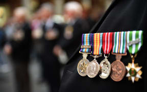 An Australian war veteran wears his medals, including a service medal from the Vietnam war (far left), at the 50th anniversary of the Vietnam Veterans Memorial Service in Sydney.