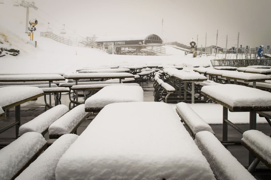 Snow blankets picnic tables at Coronet Peak.