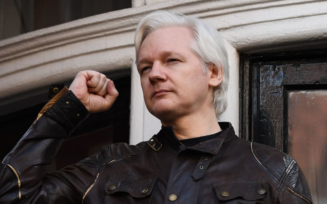 In this May 19, 2017 file photo, WikiLeaks founder Julian Assange raises his fist before addressing the media on the balcony of the Ecuadorian Embassy in London on May 19, 2017.