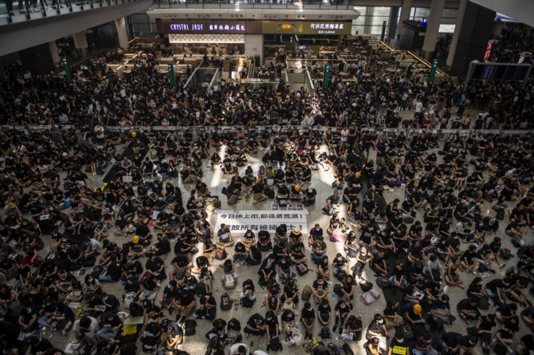 Protesters are seen sitting in the arrival hall in Hong Kong International Airport in Hong Kong.