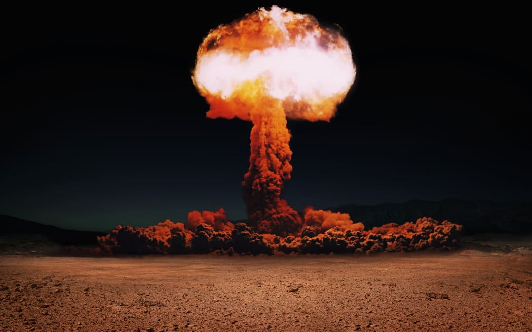 Terrible explosion of a nuclear bomb with a mushroom in the desert. Hydrogen bomb test. World War 3. Nuclear catastrophe