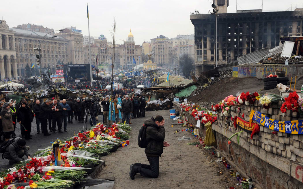 Flowers and tributes have been left at an Independence Square memorial to the anti-government protesters killed in Kiev.