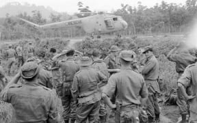 New Zealand SAS soldiers with a Bristol Sycamore helicopter of the Royal Air Force, in a photograph taken by a NZ Army photographer during the Malayan Emergency.