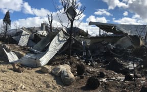 The remains of a property strewn across the land after a fire ripped through Lake Ōhau Village.