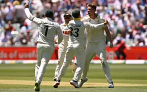Australia's Cameron Green (R) celebrates dismissing England's Harry Brooks on the second day of the third Ashes cricket Test match between Australia and England at the Adelaide Oval in Adelaide on December 18, 2025. (Photo by William WEST / AFP) / -- IMAGE RESTRICTED TO EDITORIAL USE - STRICTLY NO COMMERCIAL USE --