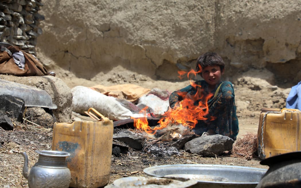 An Afghan child is seen outside of a damaged house after the magnitude 6.1 quake shakes border provinces of Paktika, Afghanistan.
