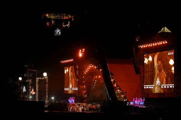 Performers take part in 'The Dreamweaver's Journey' acrobatic show in front of the pyramid stage during the first day of the Glastonbury festival at Worthy Farm in the village of Pilton in Somerset, southwest England, on June 25, 2025.