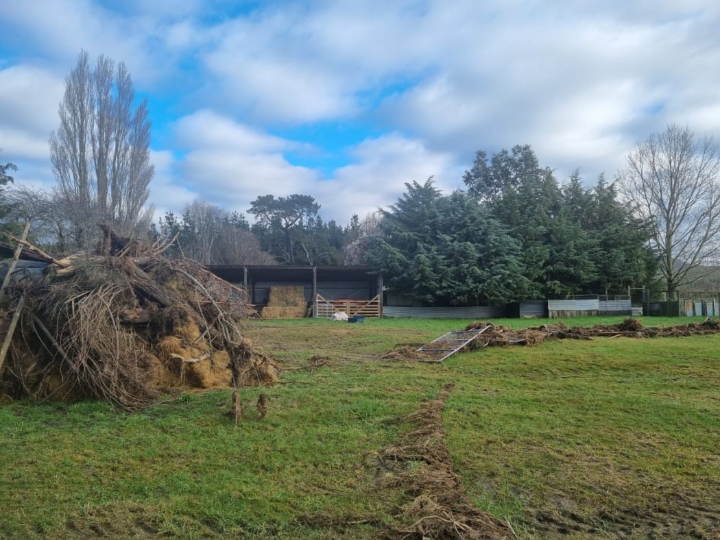 Debris left from the flooding, and a fence thrown across Gary Williams' paddock in Okuku, north Canterbury.