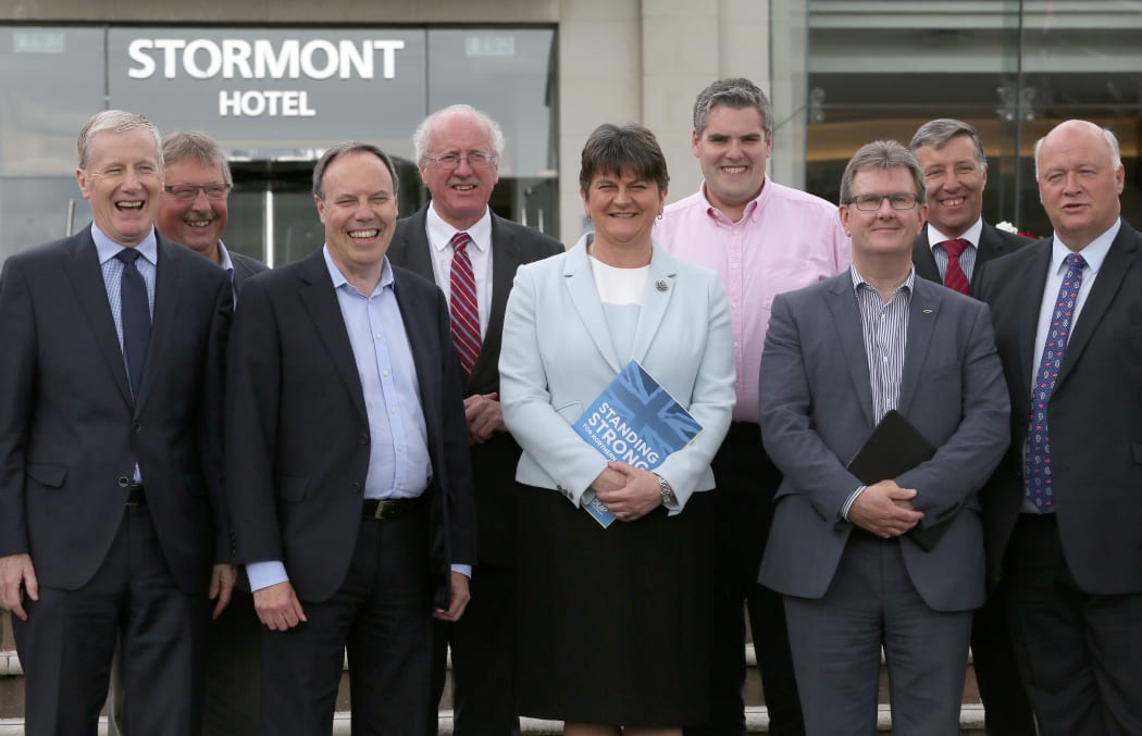 Flanked by her members of Parliament, Democratic Unionist Party (DUP) leader, and former Northern Ireland First Minister, Arlene Foster (centre), poses for a photograph outside the Stormont Hotel in Belfast, Northern Ireland, on June 9, 2017, following the result of the general election.