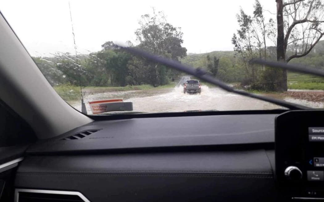 A truck tackles floodwaters on State Highway 35, which has since closed. "Rototahi is now flooded and not passable. Waka Kotahi will be closing SH35 until flooding recedes", warns Uawa Civil Defence.