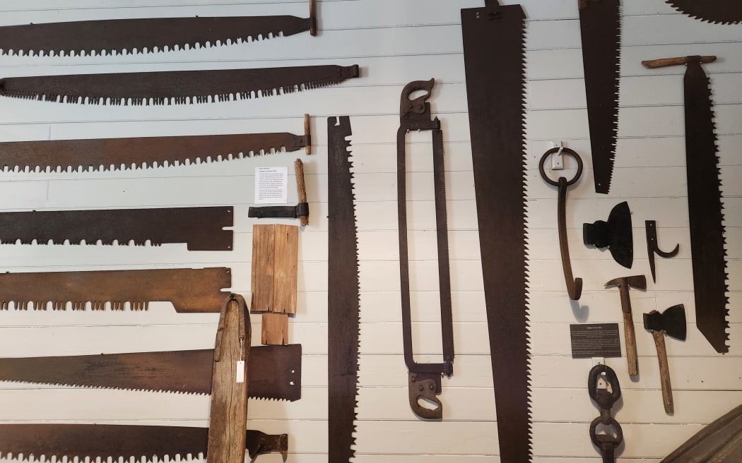 A collection of saws on the wall of the museum's display room