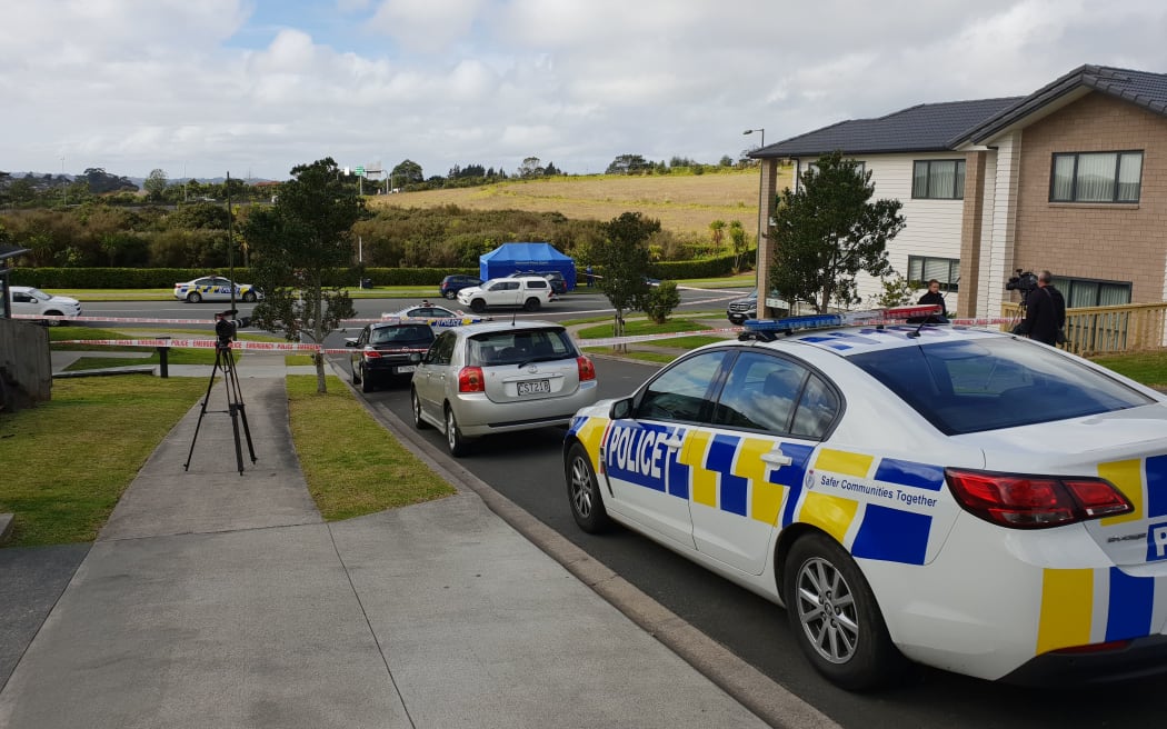 Police at the scene where a woman was fatally assaulted on Westgate Drive in Massey.