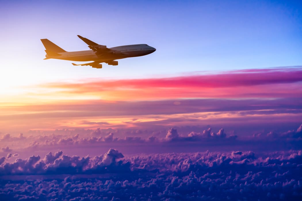 Airplane in the sky at sunrise