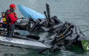 Members of the salvage team works to clear the wreckage following a collision between DS Automobiles SailGP Team France and Black Foils SailGP Team during the action on Race Day 1 of the ITM New Zealand Sail Grand Prix in Auckland