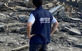 A WHO staff member surveying damage from the January 15 volcanic eruption and tsunami on Tonga's main island of Tongatapu. 2022