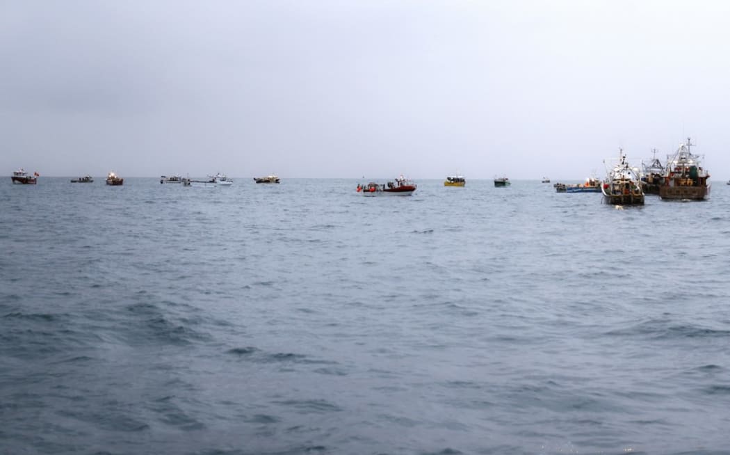 French fishing boats protest in front of the port of Saint Helier off the British island of Jersey to draw attention to what they see as unfair restrictions on their ability to fish in UK waters after Brexit, on May 6, 2021.
