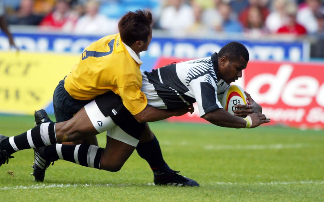 Fiji's Rupeni Caucaunibuca scores a try against Malaysia during the 2002 Commonwealth Games Sevens in Manchester.