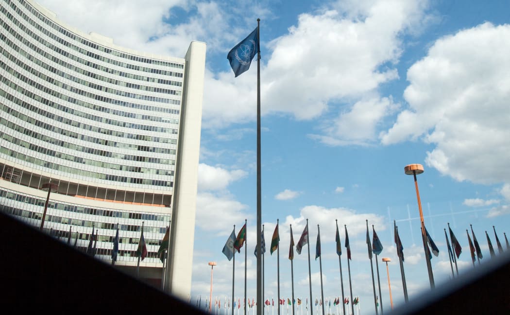 The flag of the International Atomic Energy Agency (IAEA) flutters in front of the IAEA building in Vienna on July 10, 2019.