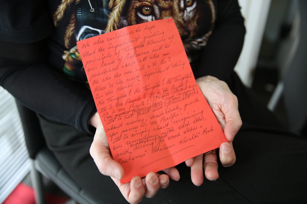 Hans Dalton's mother, Christine Wilson, holds a letter she wrote at the seventh anniversary of her son's death.