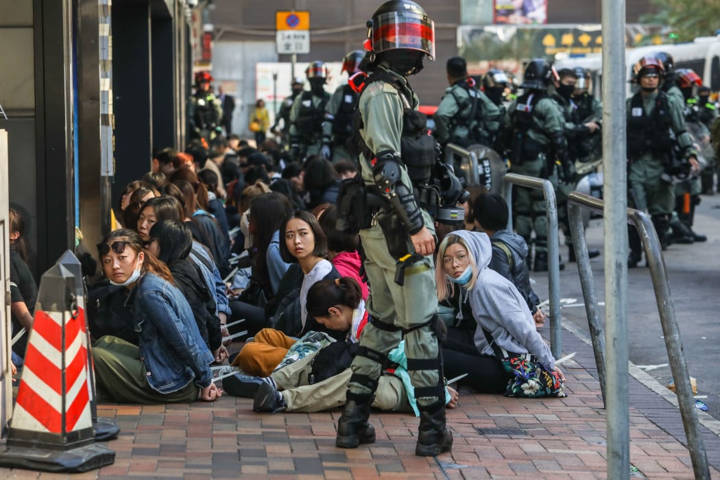 People are detained by police near the Hong Kong Polytechnic University in Hung Hom district of Hong Kong.