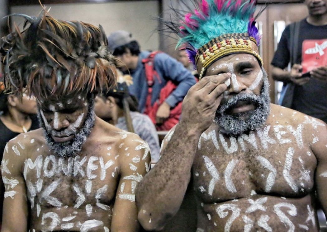 Wearing traditional headdress, Papuan human rights activists Ambrosius Mulait (left) and Dano Tabuni at the start of their trial in the Central Jakarta District Court