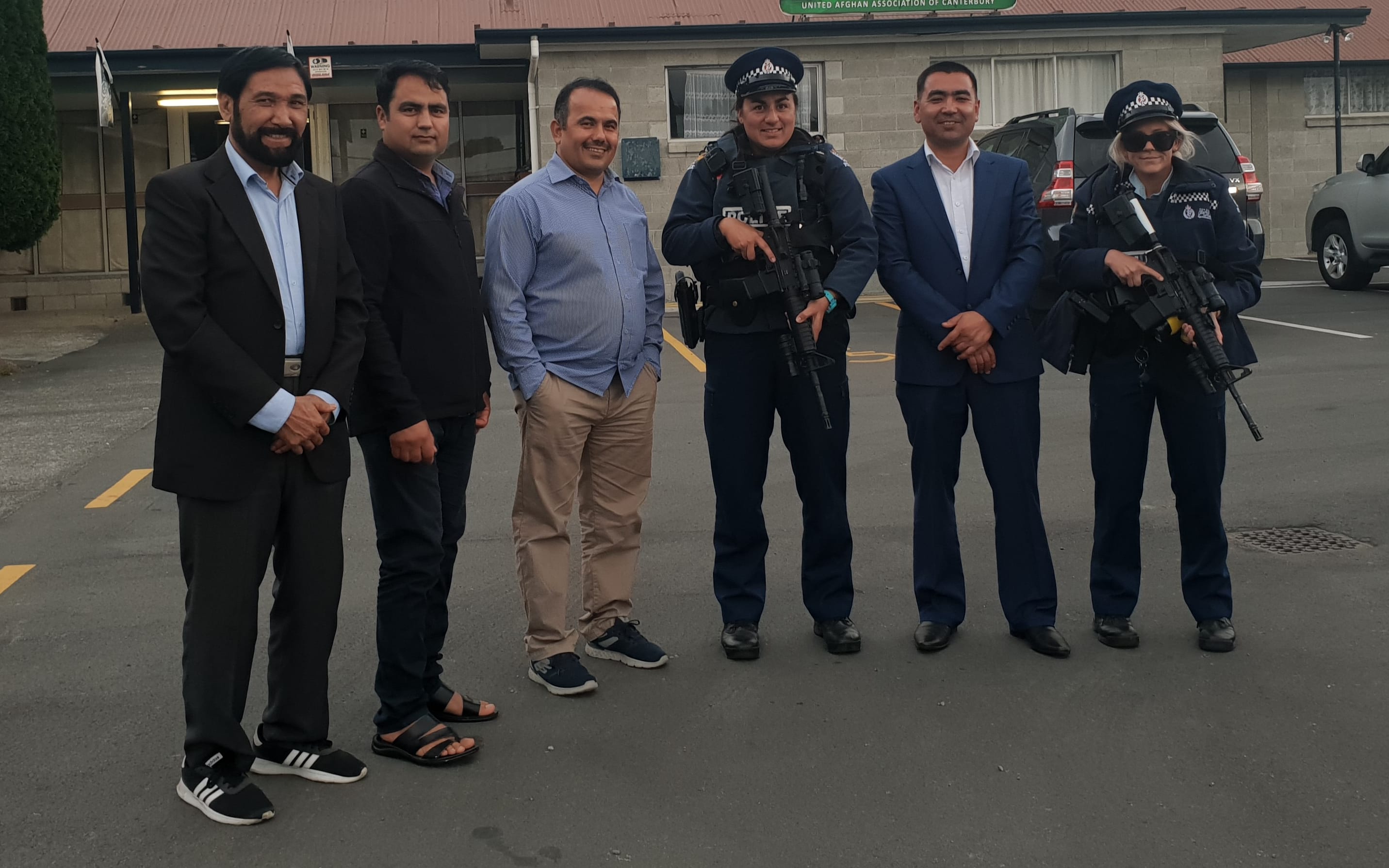 Community members from the Rasol-O-Allah Islamic Centre with armed police.