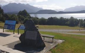 A large rock near Lake Manapouri serves as a tribute to the campaign to protect it, and marks where the water would have risen to if a proposal had gone ahead.
