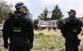 Police look on at anti-racism protestors against the 10th anniversary of the Cronulla riots rally, at the Don Lucas reserve in Cronulla, Sydney.