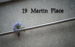 Flowers are left near the Martin Place cafe in Sydney where a 16-hour siege took place, ending with three dead.