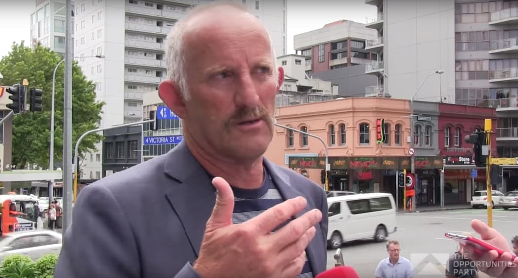 Gareth Morgan outside TVNZ HQ in Auckland telling reporters why he'd "get rid of TVNZ" - and RNZ.