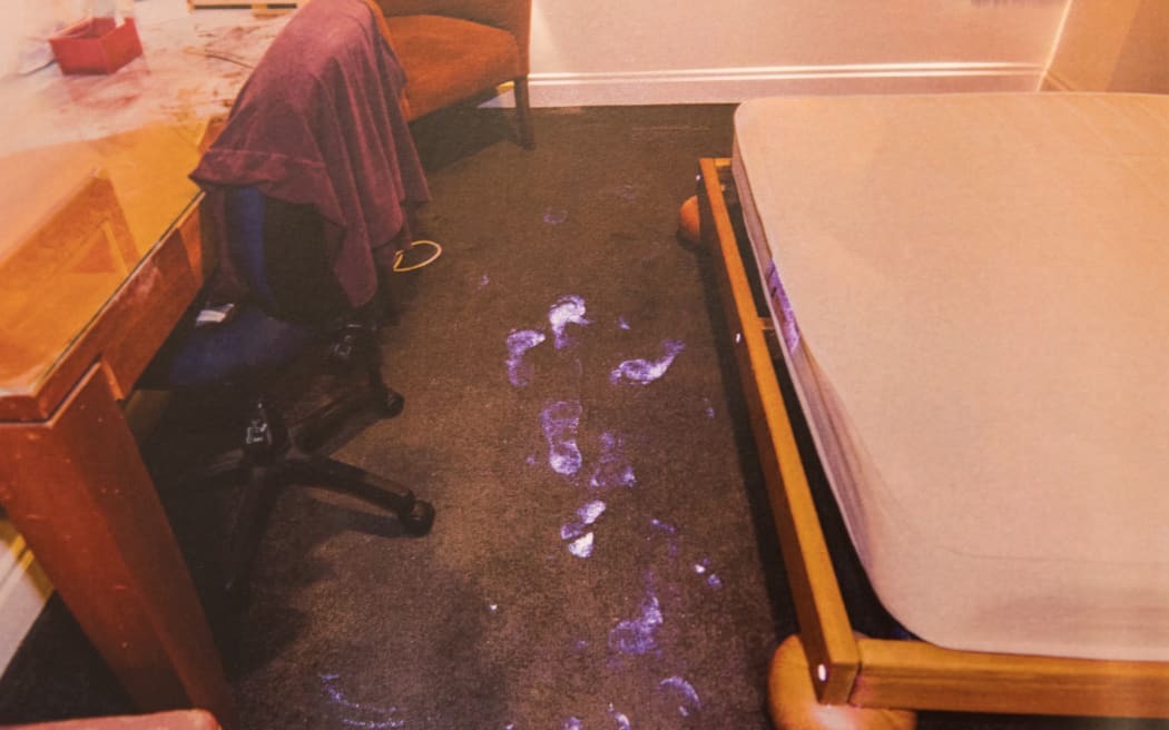 Photos showing luminol results from crime scene analysis of the hotel room