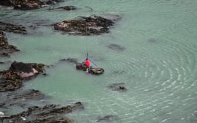A police team at a remote cove in Southland have used a helicopter to lift a vehicle linked to a missing 11-year-old out of the sea.