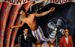 Three men on a colourful album cover.