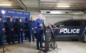 Police Commissioner Mike Bush and the new vehicle in the background.