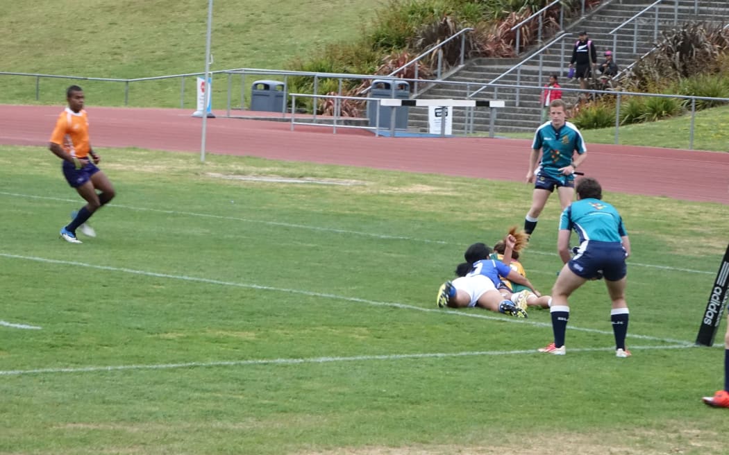 The Cook Islands women's sevens team score a try against Samoa during the Oceania Championship.