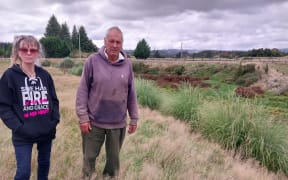 Marianne and Ken O'Malley are unhappy at the West Coast Regional Council's approach about removing pampas from their property, including the former gold dredge pond area to their left.