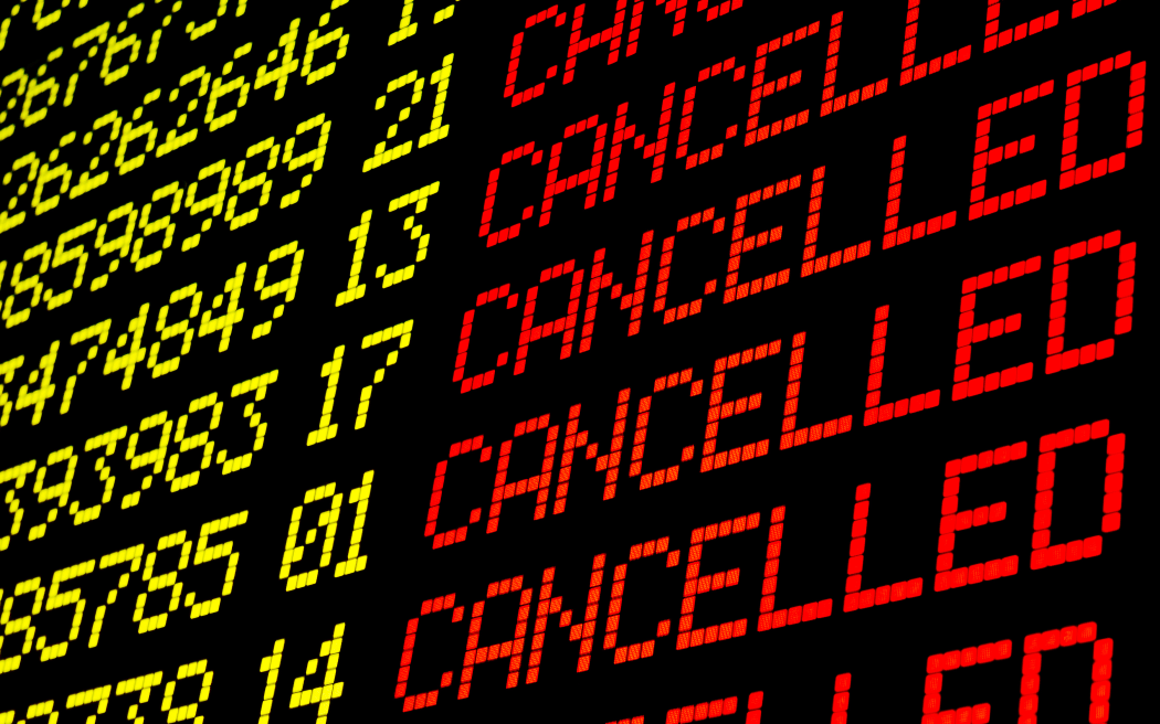 Cancelled flights on airport board panel