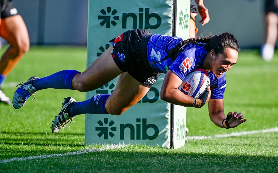 Ruahei Demant of the Blues dives to score a try.