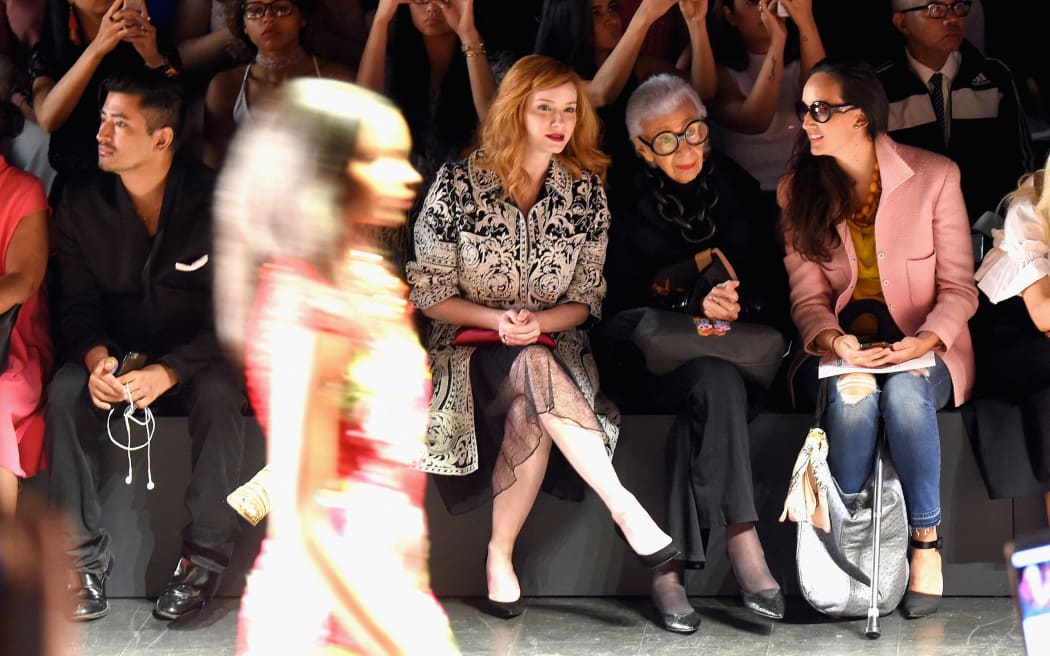 Iris Apfel sits with actress Christina Hendricks (centre) during a Naeem Khan fashion show at New York Fashion Week in 2016.