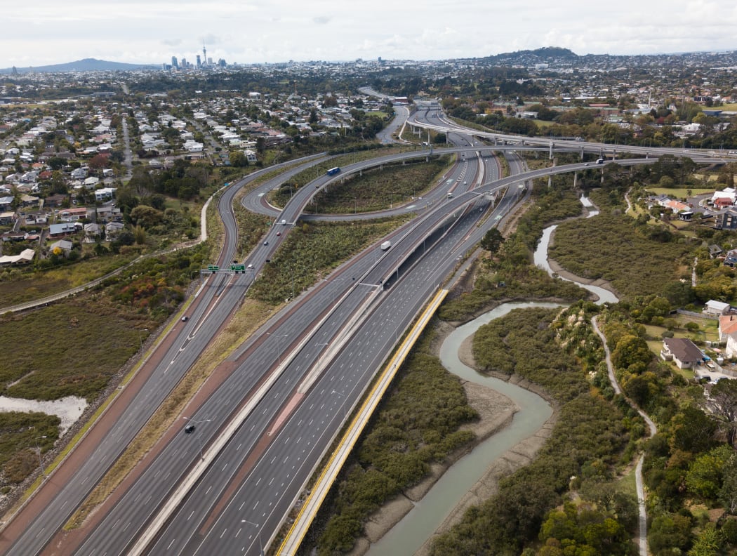 Snaking on and off ramps of the North Western Motorways empty of traffic looking back to the city.