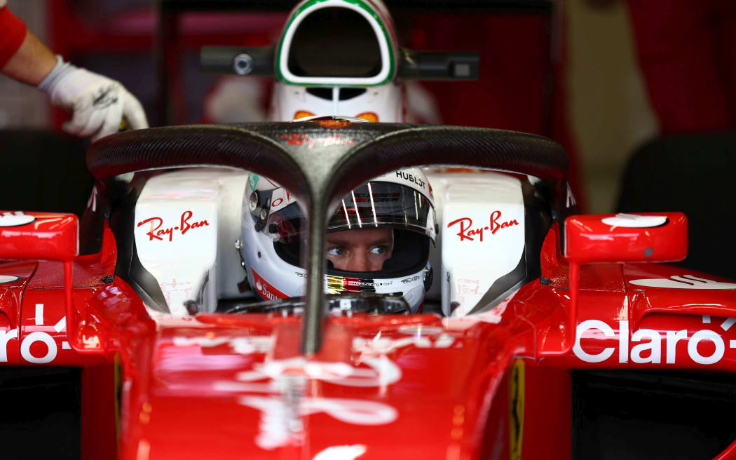 Ferrari's Sebastian Vettel test drives the halo cockpit protector.