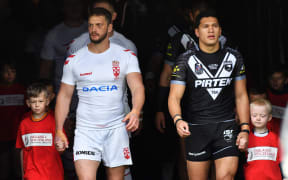 Captains Sean O'Loughlin and Dallin Watene-Zelezniak lead their teams out.
