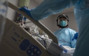 Medical staff treat a patient in the Covid-19 intensive care unit on New Year's Eve at the United Memorial Medical Center in Texas
