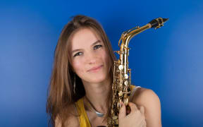 Valentine Michaud holds her saxophone