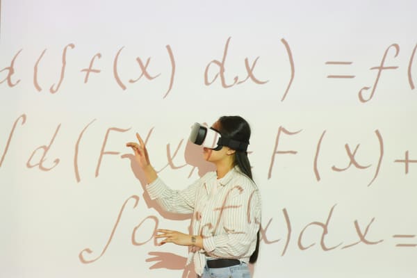 woman with VR headset and projected mathematical equations