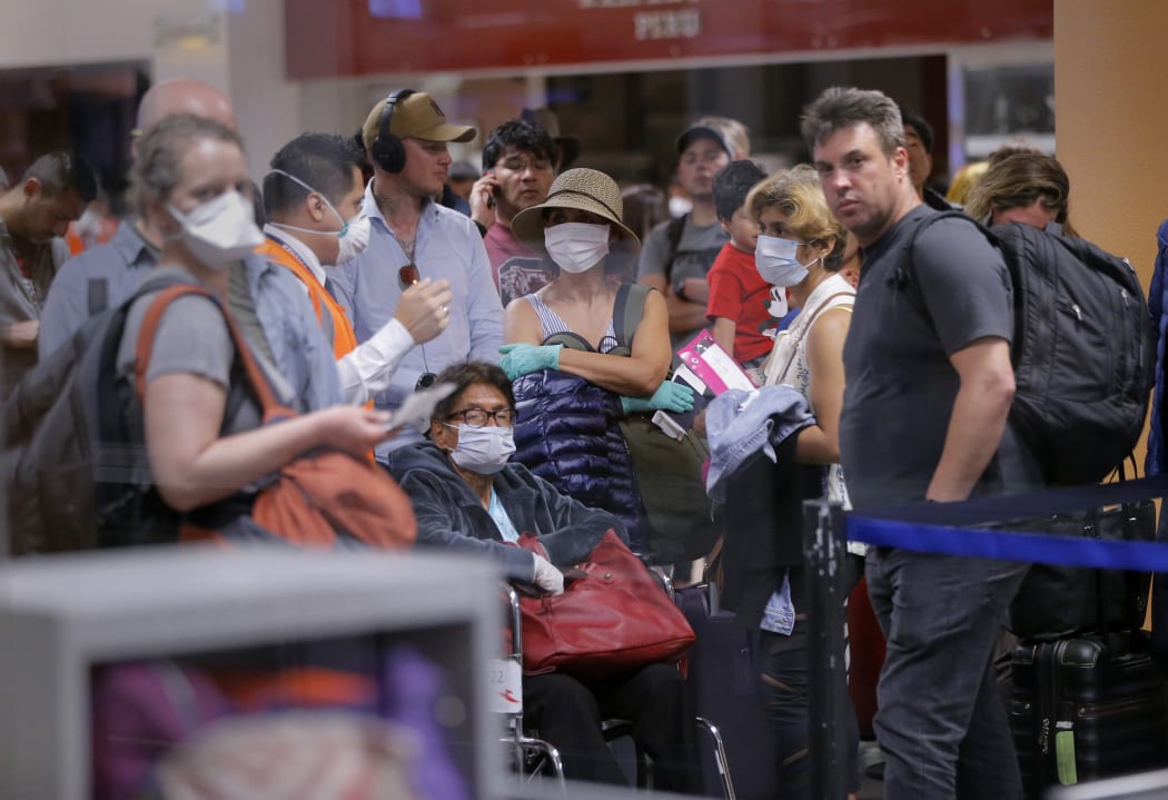 Travellers await for their flights out of Peru on March 16, 2020 at the Jorge Chavez international airport in Callao, Lima, minutes before borders are closed.