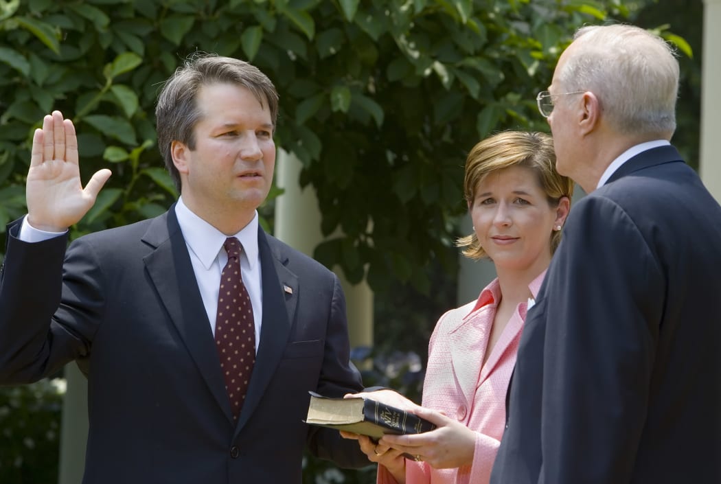 Brett Kavanaugh (left) pictured in 2006 being sworn in as a US Court of Appeals Judge for the District of Columbia.