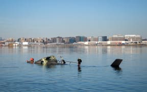 WASHINGTON, DC - JANUARY 30: (EDITOR'S NOTE: This Handout image was provided by a third-party organization and may not adhere to Getty Images' editorial policy.) In this U.S. Coast Guard handout, the Coast Guard investigates aircraft wreckage on the Potomac River on January 30, 2025 in Washington, DC. An American Airlines flight from Wichita, Kansas collided midair with a military Black Hawk helicopter while on approach to Ronald Reagan Washington National Airport outside of Washington, DC. According to reports, there were no survivors among the 67 people onboard both aircraft.   Petty Officer 1st Class Brandon Giles/ U.S. Coast Guard via Getty Images/AFP (Photo by Handout / GETTY IMAGES NORTH AMERICA / Getty Images via AFP)