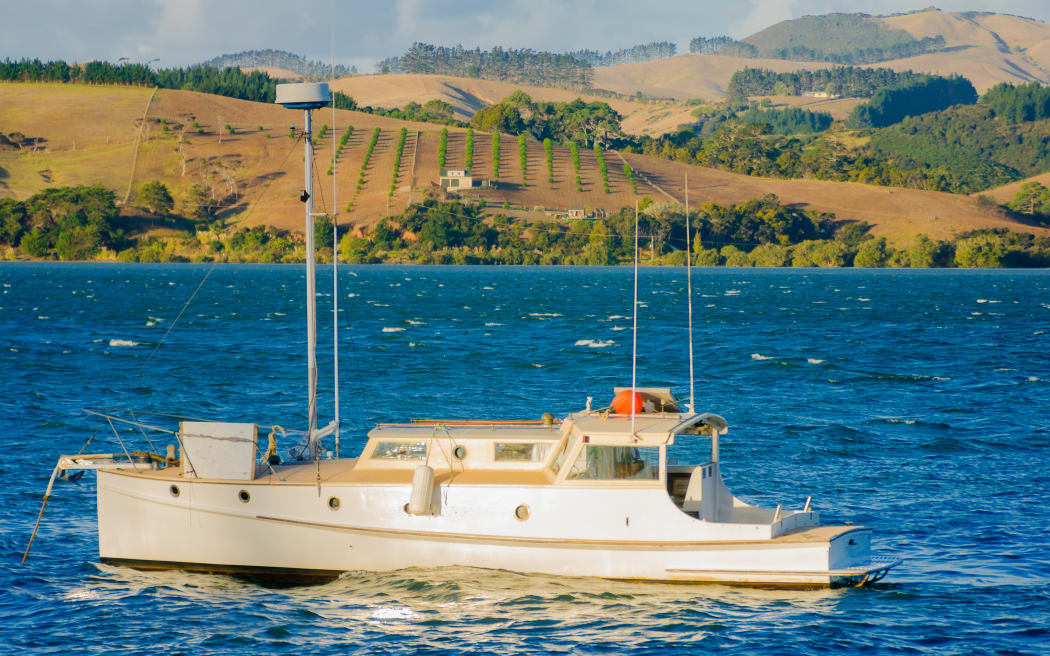 Fishing boat and landscape near Mangonui, Northland Region, New Zealand